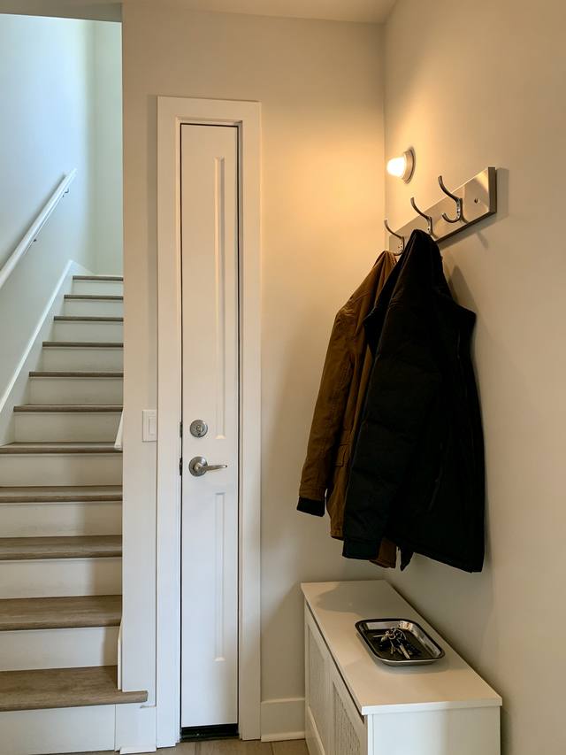 A narrow hallway with the door against the wall